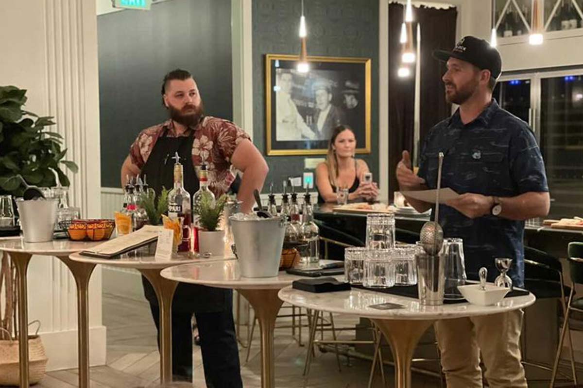 Matt Briggs standing in front of assorted cocktail tools in The Trophy Club.