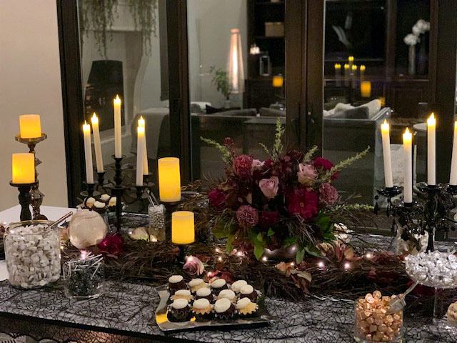 Table with purple flowers and a spread of various goodies catered by Randy Peters Catering.