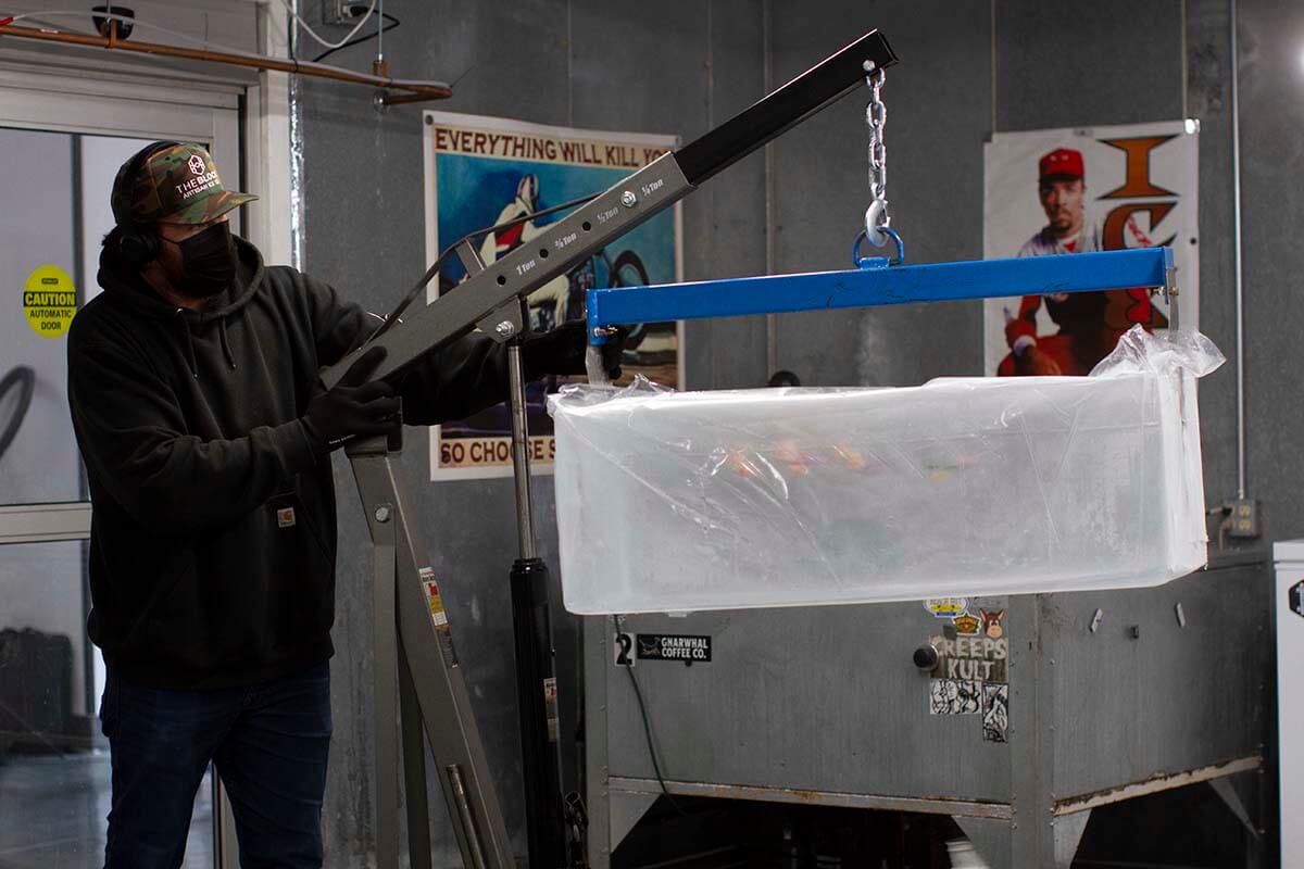 Block Ice founder Matt Briggs working with a 300-pound block of ice featuring custom infusions.